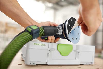 A man fits a Granat abrasive to the sanding pad