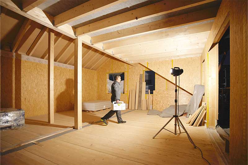 A Working light illuminates a windowless, dark room