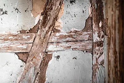 Weathered and crumbling mortar in the timber frame to be restored