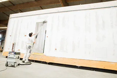 The walls of the modular buildings are machined with the Festool long-reach sander.